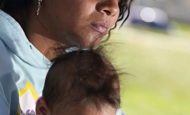 Ivanni Herrera holds her baby Milan Guzman during an interview in a park Friday, May 18, 2024, in Aurora, Colorado. (AP Photo/Jack Dempsey)