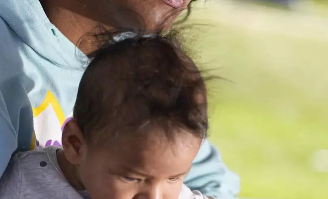 Ivanni Herrera holds her baby Milan Guzman during an interview in a park Friday, May 18, 2024, in Aurora, Colo. (AP Photo/Jack Dempsey)