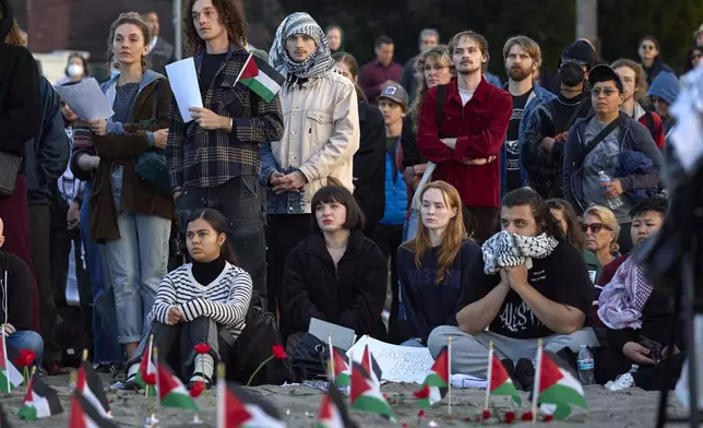 Attendees listen to speakers during a vigil on Alki Beach for the death of the 26-year old Aysenur Ezgi Eygi, killed recently in the occupied West Bank, Wednesday, Sept. 11, 2024, in Seattle. Eygi grew up in Seattle, attended Seattle Public Schools and graduated from the University of Washington. (AP Photo/John Froschauer)