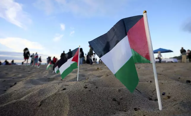 Palestinian flags are seen during a vigil on Alki Beach for Aysenur Ezgi Eygi, a 26-year-old activist from Seattle, who was killed recently in the West Bank, Wednesday, Sept. 11, 2024, in Seattle. (AP Photo/John Froschauer)