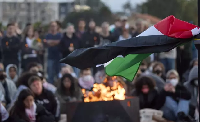 A Palestinian flag flutters in the breeze during a vigil on Alki Beach for Aysenur Ezgi Eygi, a 26-year-old activist from Seattle, who was killed recently in the West Bank, Wednesday, Sept. 11, 2024, in Seattle. (AP Photo/John Froschauer)