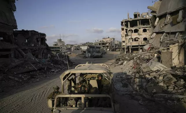 FILE - Israeli soldiers move next to destroyed buildings following Israeli strikes during a ground operation in the Gaza Strip, Sept. 13, 2024. (AP Photo/Leo Correa, File)