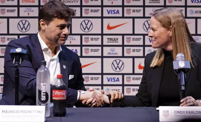 Mauricio Pochettino, left, the newly appointed head coach of the United States men's national soccer team, shakes hands with U.S. Soccer Federation President Cindy Parlow Cone at a press conference Friday, Sept. 13, 2024, in New York. (AP Photo/Adam Hunger)