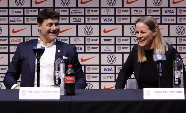 Mauricio Pochettino, left, the newly appointed head coach of the United States men's national soccer team, and U.S. Soccer Federation President Cindy Parlow Cone laugh during a press conference Friday, Sept. 13, 2024, in New York. (AP Photo/Adam Hunger)