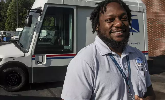 U.S. Postal Service delivery driver Richard Burton stands in the work lot of a postal facility on Thursday, Sept. 5, 2024, in Athens, Ga. (AP Photo/Ron Harris)