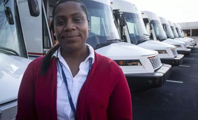 U.S. Postal Service delivery driver Avis Stonum stands in the work lot of a postal facility on Thursday, Sept. 5, 2024, in Athens, Ga. (AP Photo/Ron Harris)