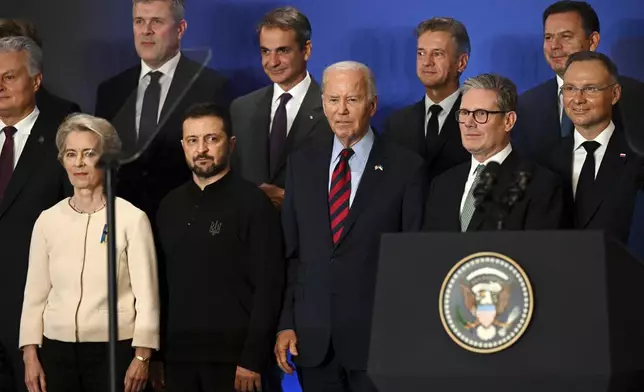 U.S. President Joe Biden, center, with Ukraine's President Volodymyr Zelenskyy, front second left, President of the European Commission Ursula von der Leyen, front left, Britain's Prime Minister Keir Starmer, front second right, President of Poland Andrzej Duda, right, and other world leaders pose for a family picture of the launching of a Joint Declaration of Support for Ukrainian Recovery and Reconstruction, Wednesday, Sept. 25, 2024, in New York. (Leon Neal/Pool Photo via AP)