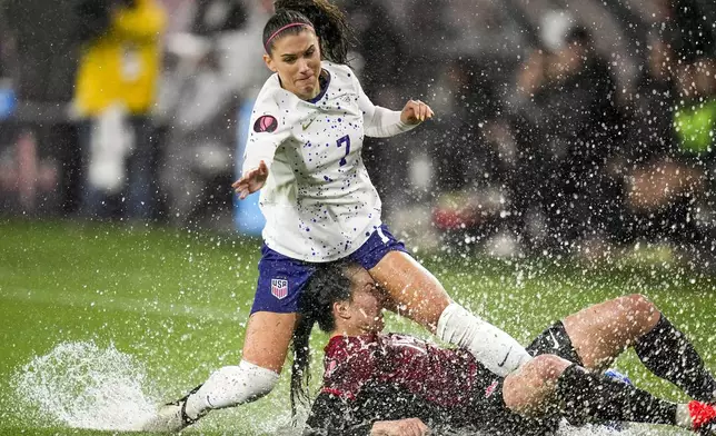 FILE - United States' Alex Morgan, above, collides with Canada's Vanessa Gilles during the first half of a CONCACAF Gold Cup women's soccer tournament semifinal match, Wednesday, March 6, 2024, in San Diego. (AP Photo/Gregory Bull, File)