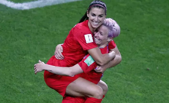 FILE - United States' Megan Rapinoe, right, congratulates teammate Alex Morgan after scoring her fifth goal during the Women's World Cup Group F soccer match between the United States and Thailand at the Stade Auguste-Delaune in Reims, France, Tuesday, June 11, 2019. (AP Photo/Francois Mori, File)