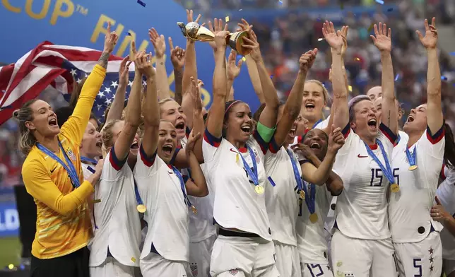 FILE - United States' Alex Morgan holds the trophy celebrating at the end of the Women's World Cup final soccer match between U.S. and The Netherlands at the Stade de Lyon in Decines, outside Lyon, France, Sunday, July 7, 2019. (AP Photo/Francisco Seco)