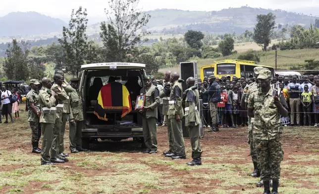 Members of the Uganda People's Defense Force carry the casket of Ugandan Olympic athlete Rebecca Cheptegei ahead of her burial in Kapkoros, Bukwo District, Uganda, on Saturday, Sept. 14. 2024. (AP Photo/Hajarah Nalwadda)