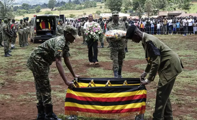 Members of the Uganda People's Defense Force carry the casket of Ugandan Olympic athlete Rebecca Cheptegei ahead of her burial in Kapkoros, Bukwo District, Uganda, on Saturday, Sept. 14. 2024. (AP Photo/Hajarah Nalwadda)