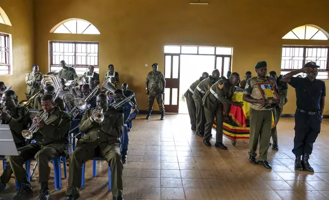 Members of Uganda People's Defence Force (UPDF) carry the coffin of their colleague Ugandan Olympic athlete Rebecca Koriny Cheptegei, ahead of her burial in Kapkoros, Bukwo District, Uganda Saturday, Sept. 14. 2024. (AP Photo/Hajarah Nalwadda)