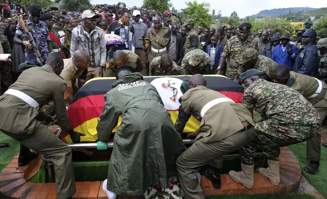 Members of the Uganda People's Defense Force lower the casket of Ugandan Olympic athlete Rebecca Cheptegei into the grave in Kapkoros, Bukwo District, Uganda, on Saturday, Sept. 14. 2024. (AP Photo/Hajarah Nalwadda)