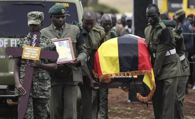 Members of the Uganda People's Defense Force carry the casket of Ugandan Olympic athlete Rebecca Cheptegei ahead of her burial in Kapkoros, Bukwo District, Uganda, Saturday, Sept. 14. 2024. (AP Photo/Hajarah Nalwadda)