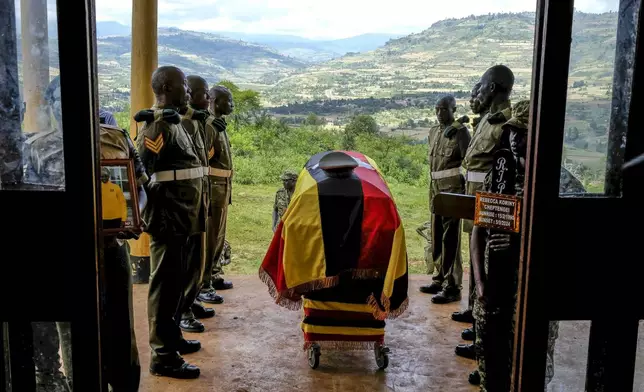 Members of Uganda People's Defence Force (UPDF) stand at the casket of their colleague Ugandan Olympic athlete Rebecca Koriny Cheptegei, ahead of her burial in Kapkoros, Bukwo District, Uganda Saturday, Sept. 14. 2024. (AP Photo/Hajarah Nalwadda)