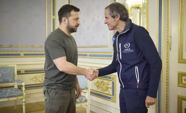 In this photo provided by the Ukrainian Presidential Press Office, Ukrainian President Volodymyr Zelenskyy, left, shakes hands with Director General of the International Atomic Energy Agency (IAEA), Rafael Mariano Grossi in Kyiv, Ukraine, Tuesday, Sept. 3, 2024. (Ukrainian Presidential Press Office via AP)