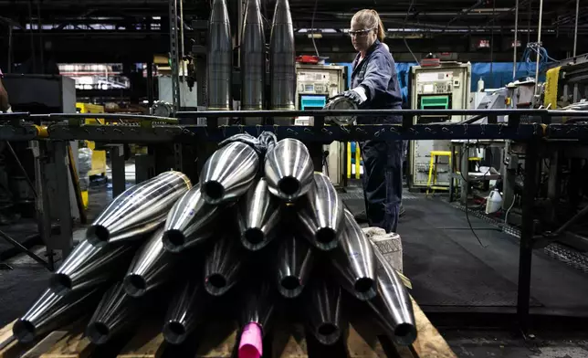 FILE -A steel worker moves a 155 mm M795 artillery projectile during the manufacturing process at the Scranton Army Ammunition Plant in Scranton, Pa., Thursday, April 13, 2023. (AP Photo/Matt Rourke, File)