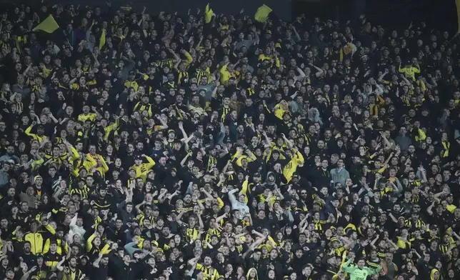 Fans of Uruguay's Penarol cheer during a Copa Libertadores quarter final second leg soccer match against Brazil's Flamengo at Campeon del Siglo Stadium in Montevideo, Uruguay, Thursday, Sept. 26, 2024. (AP Photo/Matilde Campodonico)