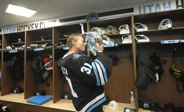 Utah Hockey Club goaltender Matt Villalta suits up in the new temporary practice facility locker room at the Olympic Oval Tuesday, Sept. 17, 2024, in Kearns, Utah. (AP Photo/Rick Bowmer)