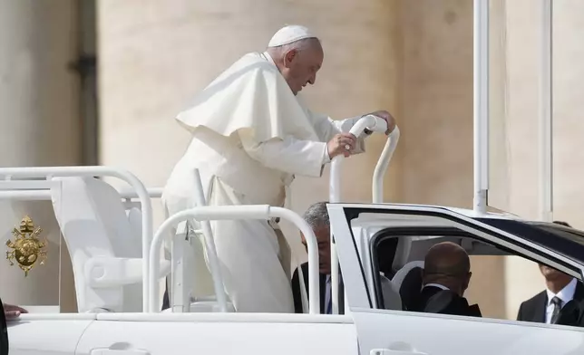 Pope Francis goes on pope-mobile as he leaves after his weekly general audience in St. Peter's Square, at the Vatican, Wednesday, Sept. 25, 2024. (AP Photo/Gregorio Borgia)