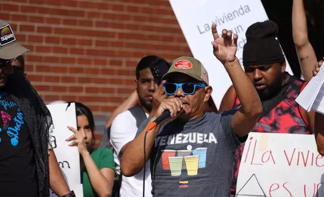 Resident Moises Didenot speaks during a rally staged by the East Colfax Community Collective to address chronic problems in the apartment buildings occupied by people displaced from their home countries in central and South America Tuesday, Sept. 3, 2024, in Aurora, Colo. (AP Photo/David Zalubowski)