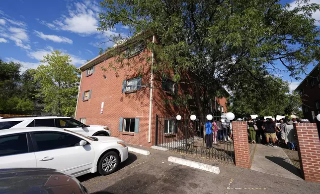 A rally in the courtyard is staged by the East Colfax Community Collective to address chronic problems in the apartment buildings occupied by people displaced from their home countries in central and South America Tuesday, Sept. 3, 2024, in Aurora, Colo. (AP Photo/David Zalubowski)