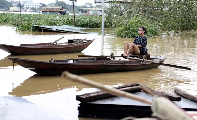 A woman paddles a boat on a flooded street, following Typhoon Yagi in Hanoi, Vietnam on Tuesday, Sept. 10, 2024. (AP Photo/Huy Han)