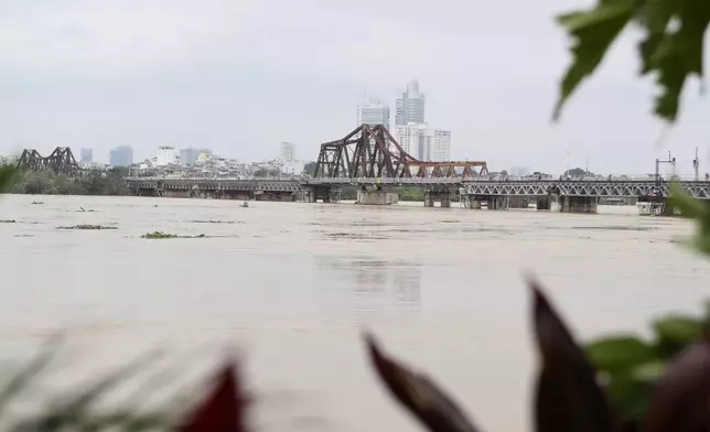 The iconic Long Bien bridge is seen on flooded Red river, following Typhoon Yagi in Hanoi, Vietnam on Tuesday, Sept. 10, 2024. (AP Photo/Huy Han)