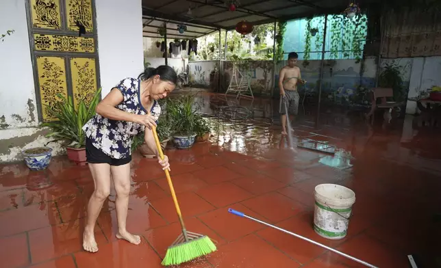 People clean their house after flood recedes in the aftermath of Typhoon Yagi in An Lac village, Hanoi, Vietnam Friday, Sept. 13, 2024. (AP Photo/Hau Dinh)