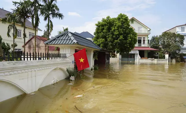 This photo shows houses submerged in flood in the aftermath of Typhoon Yagi in An Lac village, Hanoi, Vietnam Friday, Sept. 13, 2024. (AP Photo/Hau Dinh)