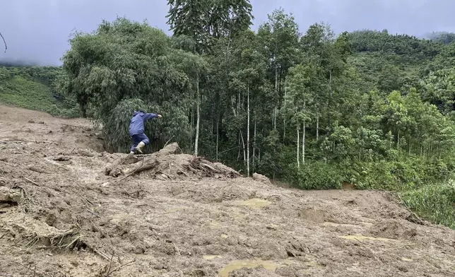 Mud and debris bury houses in Lang Nu hamlet in Lao Cai province, Vietnam Tuesday, Sep. 10, 2024. (Pham Hong Ninh/VNA via AP)