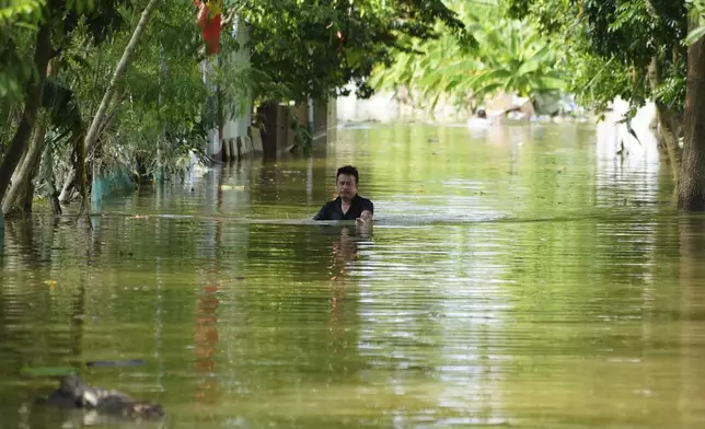 A man wades in chest deep flood in the aftermath of Typhoon Yagi in An Lac village, Hanoi, Vietnam Friday, Sept. 13, 2024. (AP Photo/Hau Dinh)