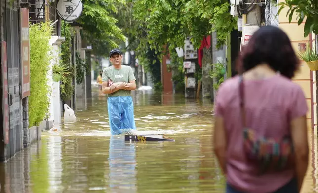 People wade in a flooded street in the aftermath of Typhoon Yagi, in Hanoi, Vietnam on Thursday, Sept. 12, 2024. (AP Photo/Hau Dinh)