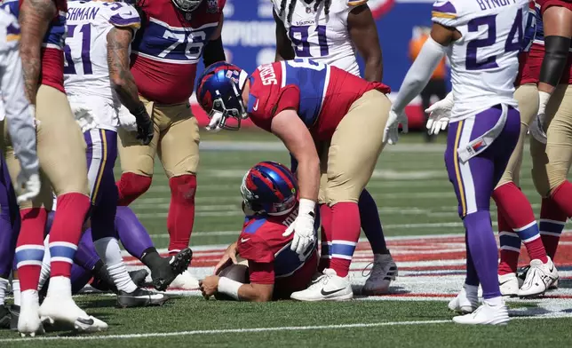 New York Giants quarterback Daniel Jones (8) lays on the ground after a tackle during the first half of an NFL football game against the Minnesota Vikings, Sunday, Sept. 8, 2024, in East Rutherford, N.J. (AP Photo/Pamela Smith)