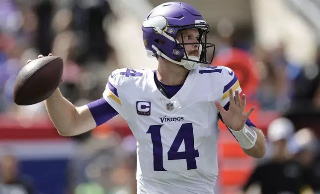 Minnesota Vikings quarterback Sam Darnold (14) passes during the first half of an NFL football game against the New York Giants, Sunday, Sept. 8, 2024, in East Rutherford, N.J. (AP Photo/Adam Hunger)