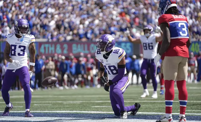 Minnesota Vikings wide receiver Justin Jefferson (18) celebrates after scoring a 3-yard touchdown against New York Giants cornerback Deonte Banks (3) during the first half of an NFL football game, Sunday, Sept. 8, 2024, in East Rutherford, N.J. (AP Photo/Pamela Smith)