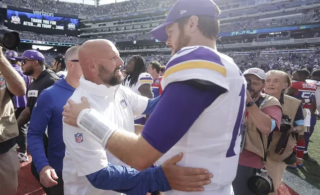 New York Giants head coach Brian Daboll and Minnesota Vikings quarterback Sam Darnold talk after an NFL football game, Sunday, Sept. 8, 2024, in East Rutherford, N.J. (AP Photo/Adam Hunger)