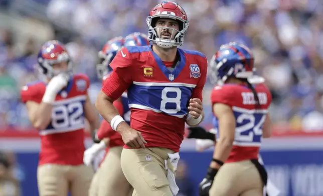 New York Giants quarterback Daniel Jones (8) jogs off the field after a third down during the first half of an NFL football game against the Minnesota Vikings, Sunday, Sept. 8, 2024, in East Rutherford, N.J. (AP Photo/Adam Hunger)