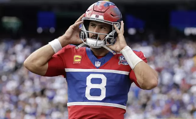 New York Giants quarterback Daniel Jones (8) walks off the field after throwing a pick-6 during the second half of an NFL football game against the Minnesota Vikings, Sunday, Sept. 8, 2024, in East Rutherford, N.J. (AP Photo/Adam Hunger)