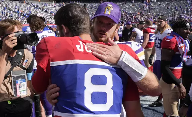 New York Giants quarterback Daniel Jones (8) and Minnesota Vikings quarterback Sam Darnold (14) hug after an NFL football game, Sunday, Sept. 8, 2024, in East Rutherford, N.J. (AP Photo/Pamela Smith)