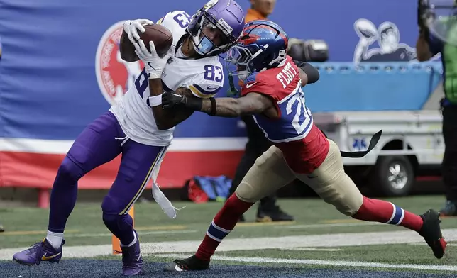 Minnesota Vikings wide receiver Jalen Nailor (83) scores a 21-yard touchdown against New York Giants cornerback Cor'Dale Flott (28) during the second half of an NFL football game, Sunday, Sept. 8, 2024, in East Rutherford, N.J. (AP Photo/Adam Hunger)