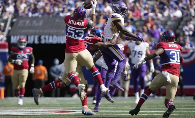 New York Giants linebacker Darius Muasau (53) intercepts a pass during the second half of an NFL football game against the Minnesota Vikings, Sunday, Sept. 8, 2024, in East Rutherford, N.J. (AP Photo/Pamela Smith)