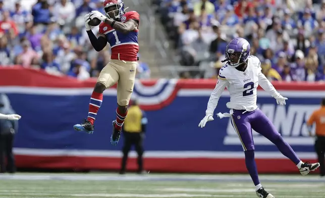 New York Giants wide receiver Malik Nabers (1) catches a pass and Minnesota Vikings cornerback Stephon Gilmore (2) defends during the second half of an NFL football game, Sunday, Sept. 8, 2024, in East Rutherford, N.J. (AP Photo/Adam Hunger)