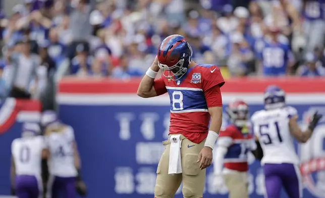 New York Giants quarterback Daniel Jones (8) reacts after throwing a pick-6 during the second half of an NFL football game against the Minnesota Vikings, Sunday, Sept. 8, 2024, in East Rutherford, N.J. (AP Photo/Adam Hunger)