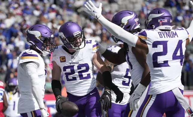 Minnesota Vikings safety Harrison Smith (22) celebrates with teammates after intercepting a pass during the second half of an NFL football game against the New York Giants, Sunday, Sept. 8, 2024, in East Rutherford, N.J. (AP Photo/Pamela Smith)