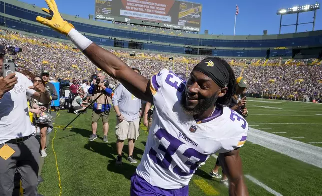 Minnesota Vikings running back Aaron Jones (33) waves to fans before an NFL football game against the Green Bay Packers, Sunday, Sept. 29, 2024, in Green Bay, Wis. (AP Photo/Morry Gash)