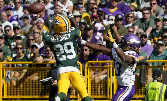 Green Bay Packers safety Xavier McKinney (29) intercepts a pass intended for Minnesota Vikings running back Aaron Jones, right, during the second half of an NFL football game Sunday, Sept. 29, 2024, in Green Bay, Wis. (AP Photo/Morry Gash)