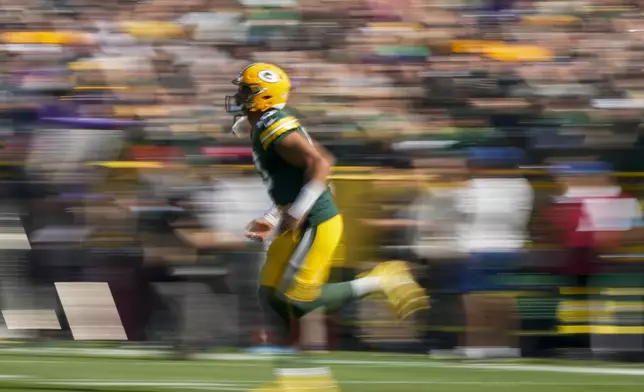 Green Bay Packers quarterback Jordan Love runs onto the field before an NFL football game against the Minnesota Vikings, Sunday, Sept. 29, 2024, in Green Bay, Wis. (AP Photo/Morry Gash)