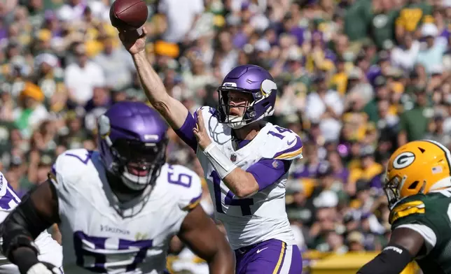 Minnesota Vikings quarterback Sam Darnold (14) throws a pass during the first half of an NFL football game against the Green Bay Packers, Sunday, Sept. 29, 2024, in Green Bay, Wis. (AP Photo/Morry Gash)